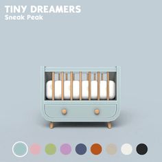 the tiny crib is painted in pastel colors