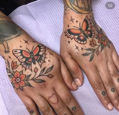 two people with tattoos on their hands and one has a butterfly tattoo on the other hand