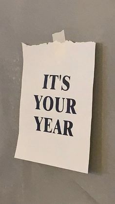 a piece of paper with the words it's your year written on it hanging on a wall