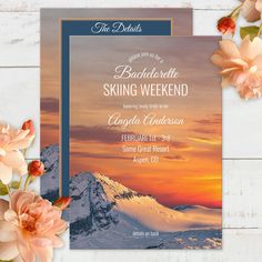 an image of a wedding card with flowers in front of the mountains and sunset behind it