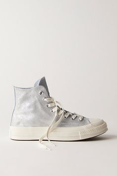 Metallic suede uppers make these high-top Converse a step above the rest. **Features:** High-top style, metallic suede uppers, rubber toe cap, rubber outsole, lace-up closure **Why We | Chuck 70 Suede Shimmer High Top Sneakers by Converse at Free People in Silver, Size: US 8 M High-top Suede Sneakers With Rubber Heel Cap, Suede High-top Sneakers With Gum Sole, Fall Season Suede High-top Sneakers For Streetwear, Fall Suede High-top Sneakers For Streetwear, Metallic Sneakers With Speckled Midsole For Streetwear, Metallic High-top Sneakers With Speckled Midsole, Suede High-top Sneakers With Rubber Heel Cap, High-top Sneakers With Gum Sole, High-top Sneakers With Gum Sole For Fall