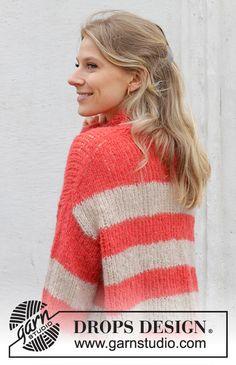 a woman wearing a red and white striped sweater with her hair in a pony tail