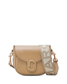 Marc Jacobs The Covered J Marc Saddle Bag Beige Flap Shoulder Bag With Branded Hardware, Luxury Camel Bag With Adjustable Strap, Beige Leather Saddle Bag With Gold-tone Hardware, Travel Systems For Baby, Leather Saddle Bags, Baby Boy Shoes, Fabric Gift Bags, Saddle Bag, Large Tote Bag