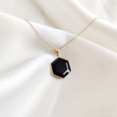 This stunning pendant is set in 14K Solid Yellow Gold with Natural Black Onyx with utmost precision. It is an unique gemstone pendant for nearly every occasion and is completely hassle-free jewelry. ITEM DETAILS * Gem: Black Onyx * Gem Size: 15X15mm * Gem Shape: Hexagon * Gem Weight: 5.83 carats * Gold Purity: 14KT  * Gold Weight: 0.61 gram * Total Weight of the Pendant: 1.76 gram The Gold purity is guaranteed and it comes with authentic 14KT gold hallmark. Since my items are handmade, they are absolutely nickel and lead free. CUSTOMIZATION * Gemstone customization is available and it can be substituted with a gem of your choice. Kindly message me for the same. PACKAGING * The Pendant comes with layers of safe and secure wrapping along with Free handmade jewelry box with every purchase. ➡️ Hexagon Faceted Formal Jewelry, Elegant Hexagon Gemstone Jewelry, Black Octagon Gemstone Jewelry, Hexagon Gemstone Jewelry In 14k Gold, Elegant Faceted Hexagon Necklace, Elegant 14k Gold Hexagon Necklace, Elegant Hexagon Faceted Necklace, Black Hexagon Jewelry Gift, Black Hexagon Jewelry For Formal Occasions