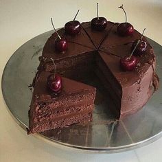 there is a chocolate cake with cherries on it