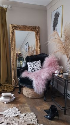 a living room with a chair, mirror and other items on the floor in front of it