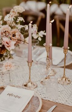 the table is set with candles and place settings