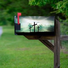 a mailbox with the image of three crosses painted on it's front and back