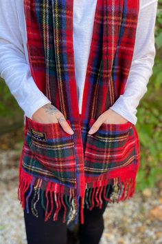 A super functional, cozy and cute winter scarf! This scarf features a plaid print, fringe edges and even has pockets to help keep your hands cozy warm. Casual Red Winter Scarf, Red Casual Scarves For Fall, Casual Red Scarf For Fall, Plaid Scarves For Cold Weather In Winter, Red Winter Scarves For Cold Weather, Red Scarves For Winter Cold Weather, Casual Red Scarf For Cold Weather, Casual Plaid Scarves For Cold Weather, Cozy Red Scarves For Winter