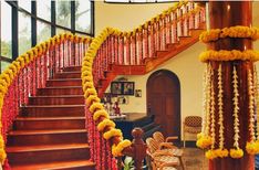 a staircase decorated with yellow and red garlands