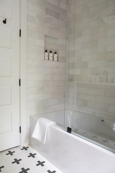 a white bath tub sitting next to a doorway