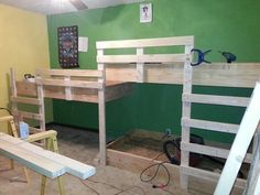 bunk beds are being constructed in a room with green walls