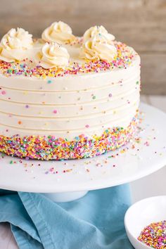 a cake with white frosting and sprinkles