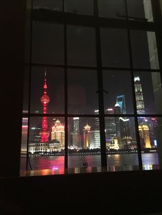 a window with a view of the city at night