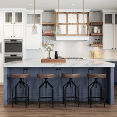 a kitchen with three stools in front of an island and white cupboards on the wall