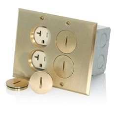 an electrical outlet with three outlets and two plates on each side, in gold color