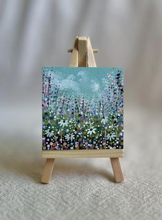 a small easel with a painting on it