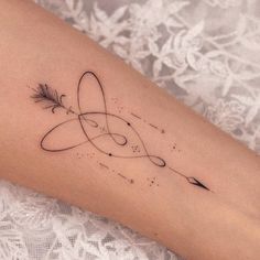 a woman's arm with an arrow tattoo on it