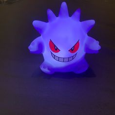 a glowing toy with red eyes and big teeth