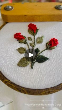 a close up of a piece of cloth with flowers on it and a wooden frame