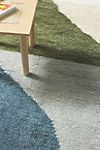 a wooden table with a blue rug on it