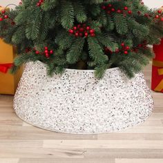 a potted christmas tree with red berries on it