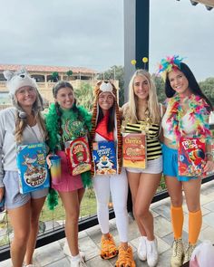 four girls dressed in costumes posing for the camera