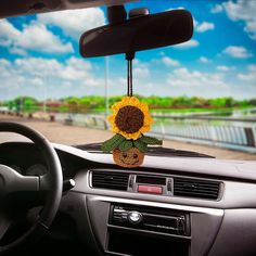 a car dashboard with a sunflower in the center