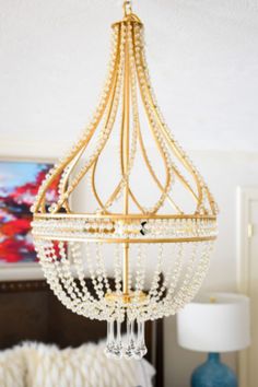 a chandelier hanging from the ceiling in a bedroom