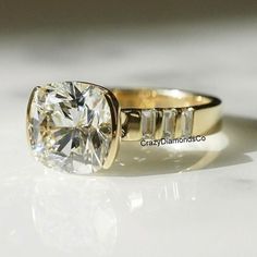 a yellow gold engagement ring with a cushion cut diamond