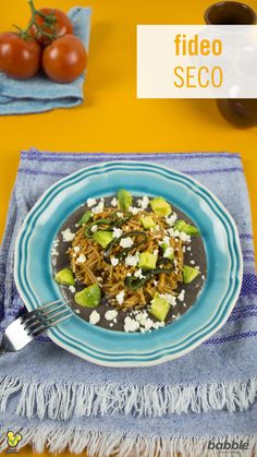 a blue plate topped with noodles and vegetables