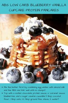 a stack of pancakes covered in blueberries and syrup