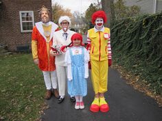 three adults and two children dressed up in costumes