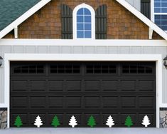 the garage door is decorated with christmas trees