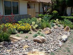 a rock garden in front of a house