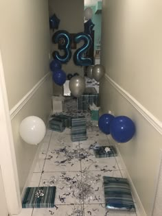 balloons and streamers are scattered on the floor in this hallway decorated for a 30th birthday