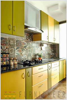 a kitchen with yellow cabinets and tile backsplashes on the counter top,