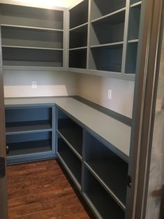 an empty walk in closet with lots of shelves