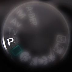 a close up of a button on a car's dashboard with the word p in it