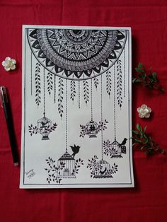 a red table topped with flowers and a drawing on top of a piece of paper