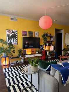 a living room with yellow walls and black and white checkered rug