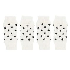 four pairs of white and black polka dot fingerless mitts with black dots on them