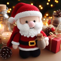 a crocheted santa clause doll next to a christmas tree with lights in the background