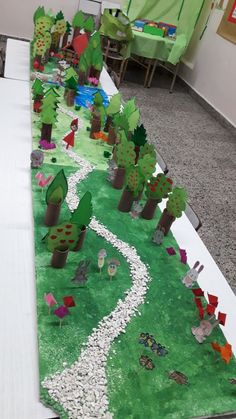 a long table with paper cut trees on it