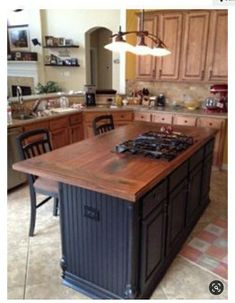 a kitchen with an island in the middle of it