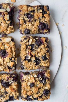 blueberry granola bars cut into squares on a plate