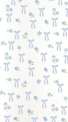 a white wall with blue flowers and bows on it