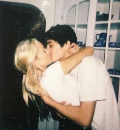 a man and woman kissing each other in front of a bookcase with the caption's quote