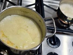 a pot filled with food sitting on top of a stove next to two burners