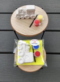 two small wooden trays with toys on them